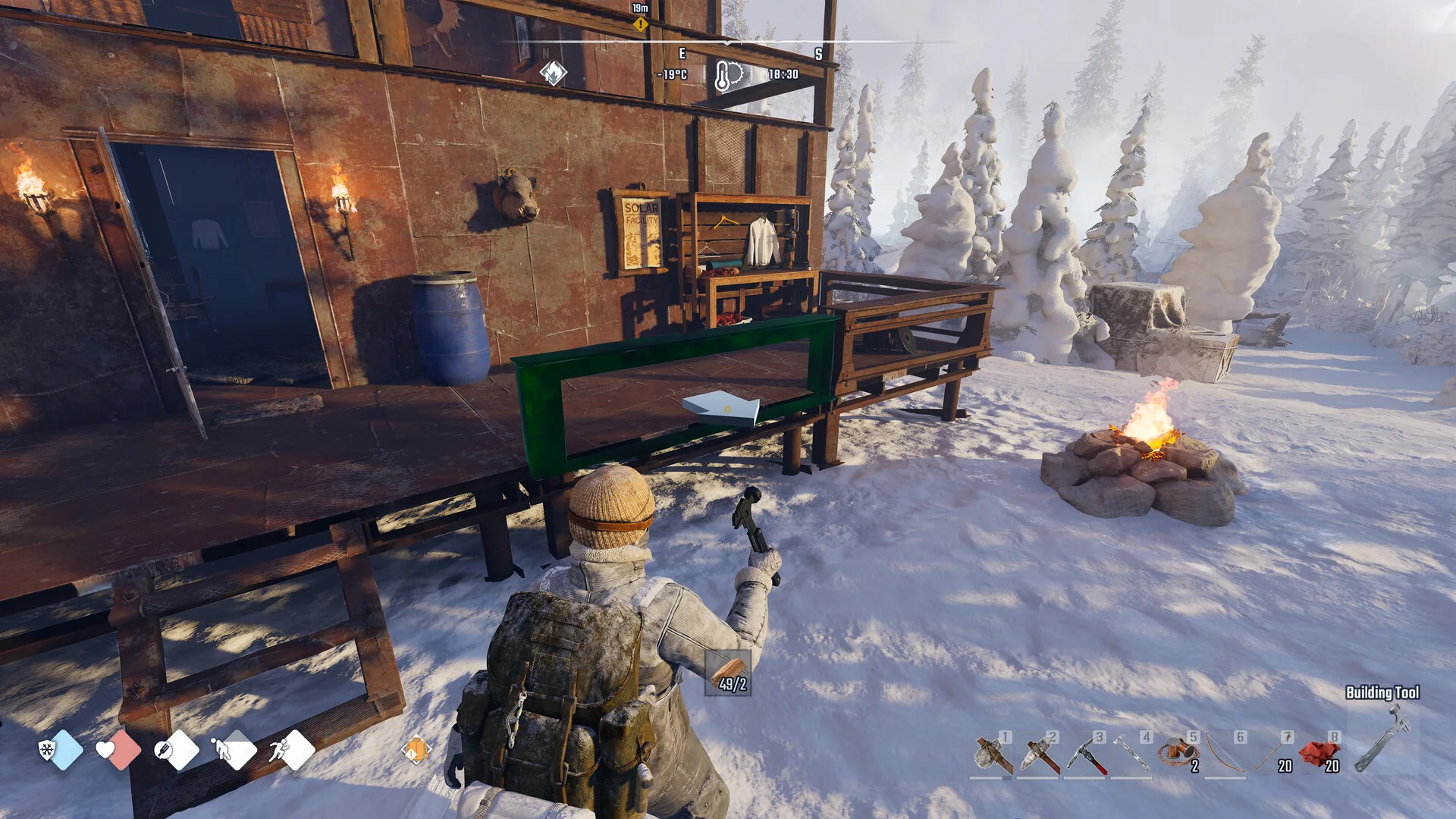 Survivor at an outdoor workbench beside a campfire in Permafrost